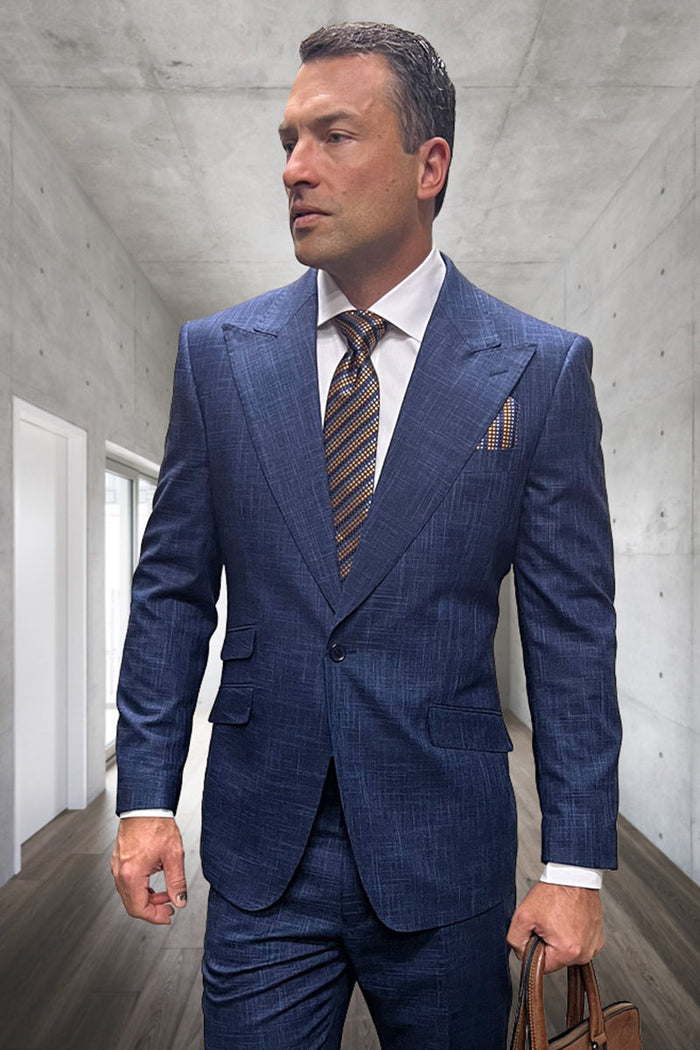 Indigo blue plaid wool suit. Tailored fit, peak lapels, single-button closure, structured shoulders. Flat front trousers. Textured plaid pattern. Includes contrasting tie and pocket square.
