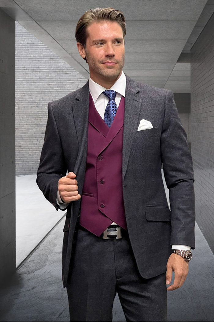 Men's charcoal grey wool-cashmere suit with subtle plaid. Modern fit, tailored jacket & trousers. Textured fabric, notched lapel. Deep burgundy vest adds contrast.
