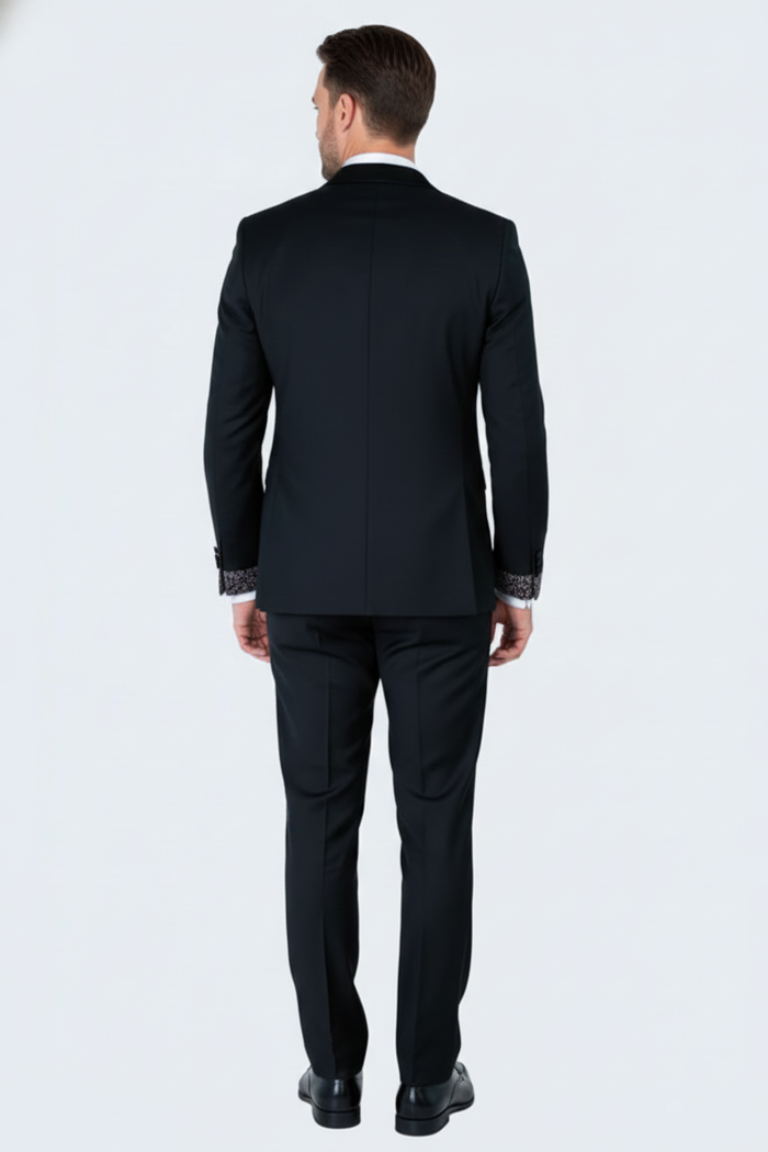 Men's black tuxedo suit with fitted silhouette, silver cuff accents, and smooth fabric. Traditional collar, straight-cut trousers. Elegant and stylish formal wear.
