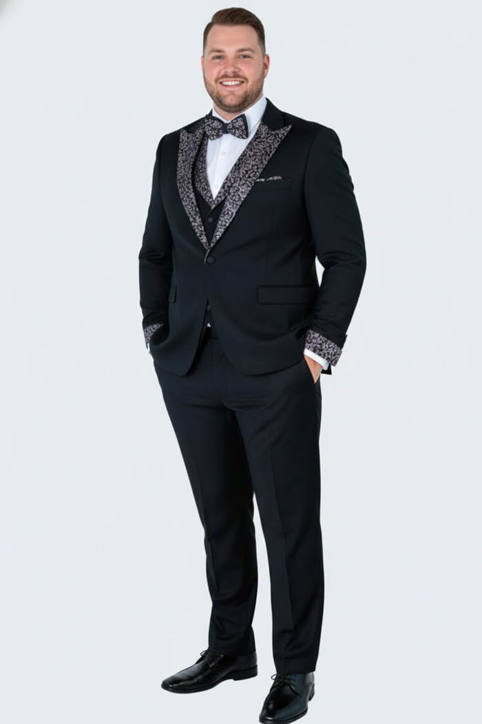 Men's tuxedo: black jacket with silver shawl collar and cuff details, paired with black trousers. Includes white shirt and bow tie. Classic formal wear.
