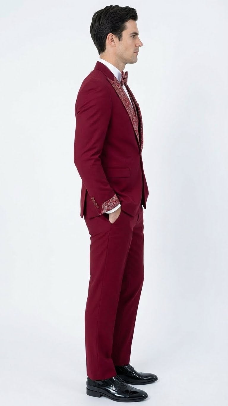 Burgundy men's tuxedo with white embellished detailing. Structured jacket with intricate lapels and matching tailored trousers. Sleek and sophisticated.
