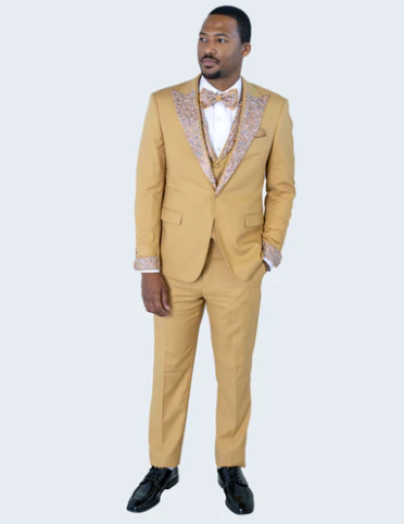 Alberto Nardoni's men's gold tuxedo suit: fitted, single-breasted jacket, matching trousers. Gold embellishments on shawl lapel and cuffs. Rich gold color with satin finish. Includes white shirt, patterned bow tie.
