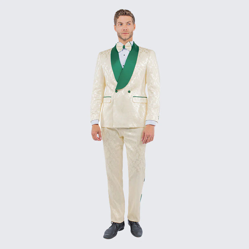 Ivory jacquard tuxedo suit with emerald green shawl lapel. Single-breasted, contrasting pocket trim, and matching patterned trousers. A sophisticated look for men.
