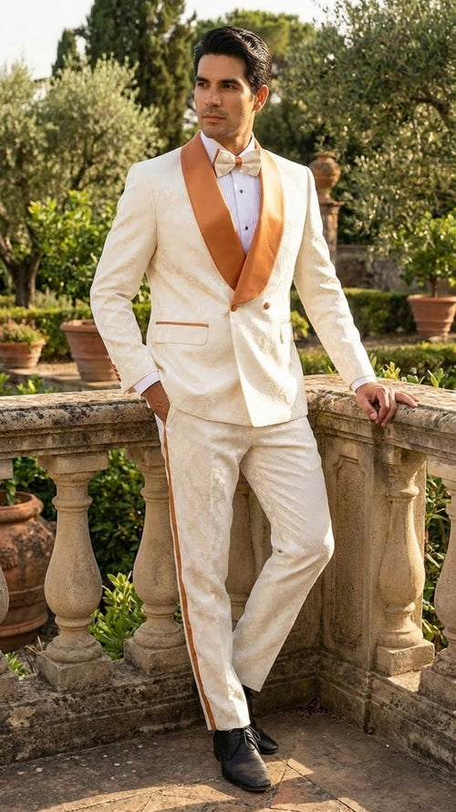 Ivory and gold jacquard tuxedo suit. Fitted jacket: gold satin shawl collar, single button. Textured pattern. Gold side stripe trousers.
