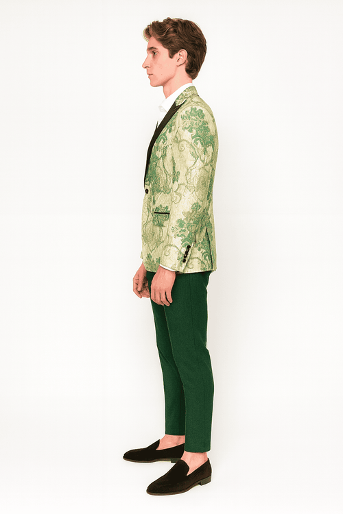 Men's ivory suit with floral embroidered tuxedo jacket, black satin lapel, and hunter green pants. Intricate floral patterns on the ivory jacket.
