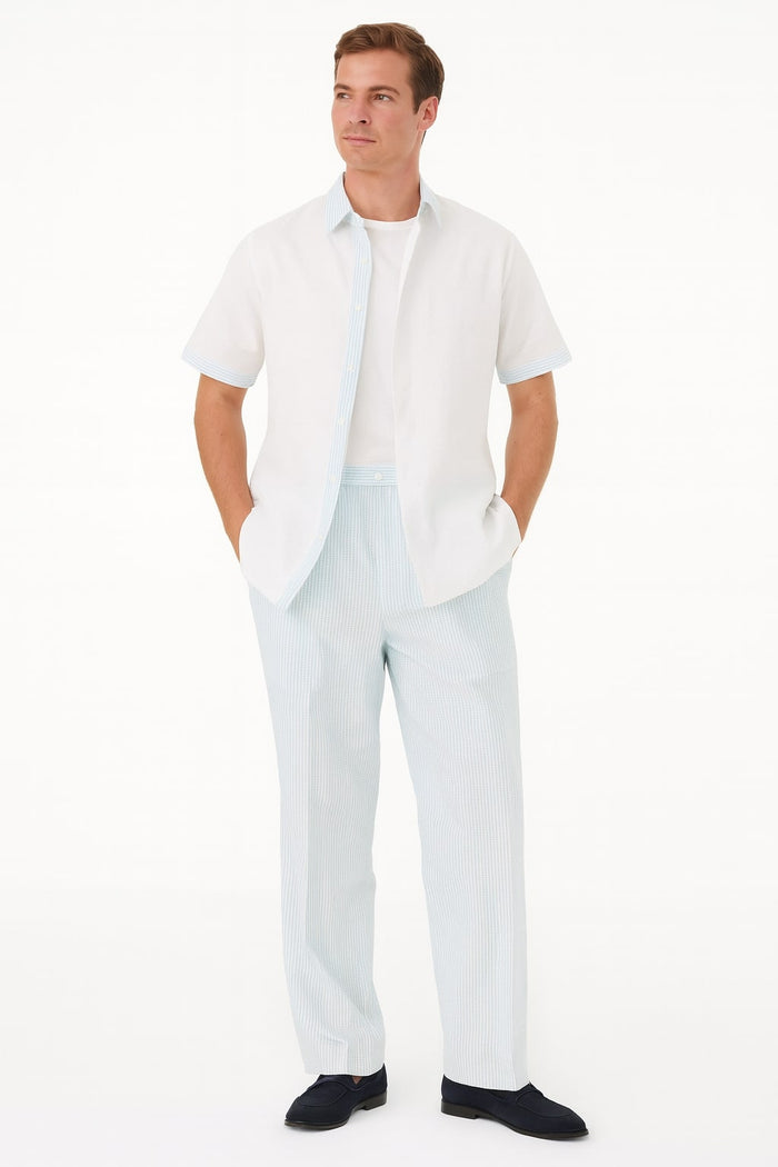 Men's sky blue two-piece set: button-up shirt with collar, solid color. Pants: loose fit, light blue & white stripes, elastic waist. Casual wear, visible stitching, light fabric.
