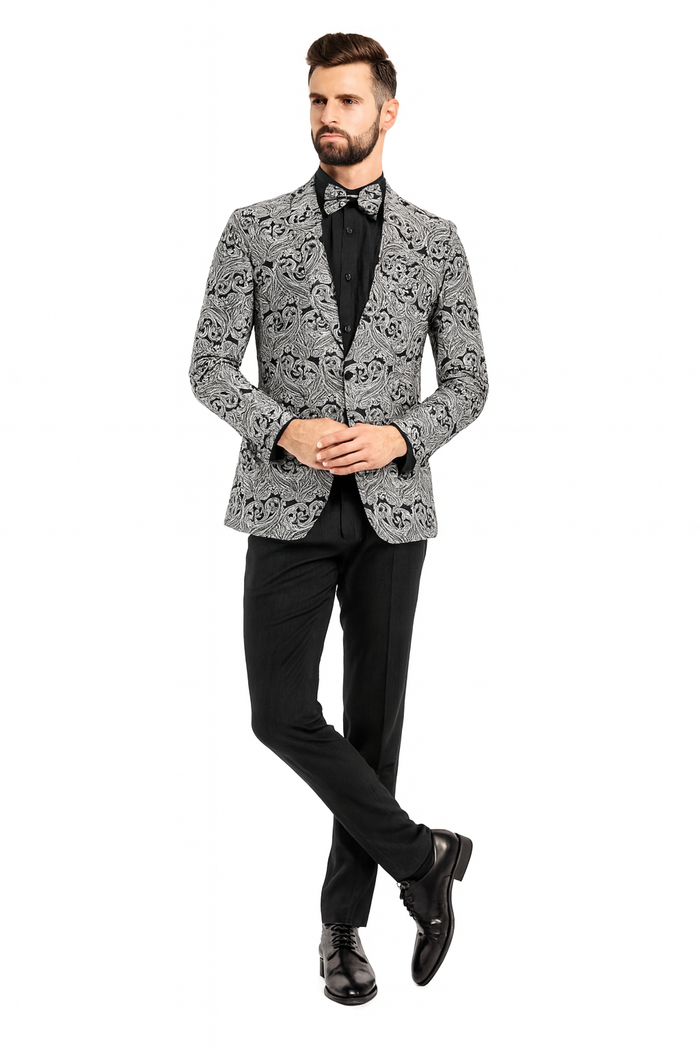 Men's slim-fit black & silver paisley tuxedo jacket. Features a patterned exterior, single-button closure, and is styled with a matching bow tie and black pants.
