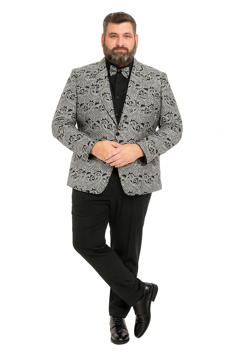 Men's black & silver paisley tuxedo jacket (slim fit) with matching bow tie. Worn over black shirt, paired with black pants & shoes. Elegant paisley pattern.
