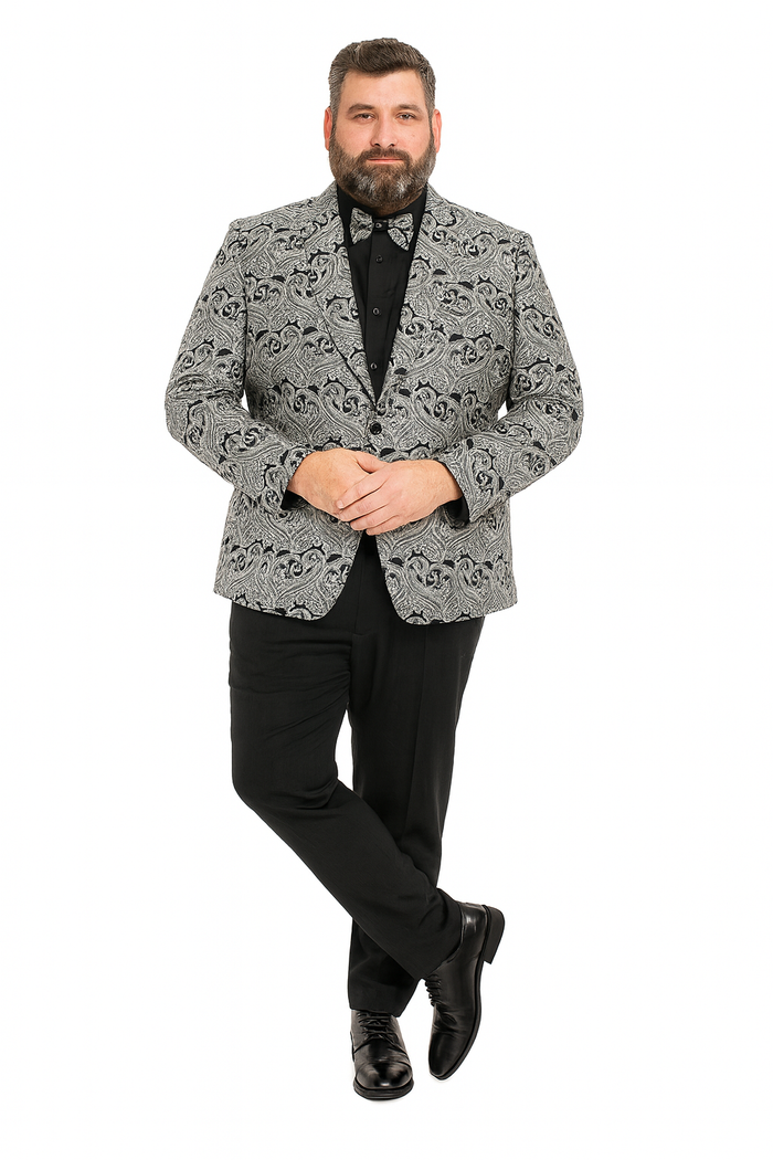 Men's black & silver paisley tuxedo jacket (slim fit) with matching bow tie. Worn over black shirt, paired with black pants & shoes. Elegant paisley pattern.
