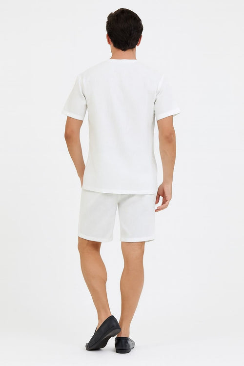 White men's short set: V-neck shirt and shorts. Soft, lightweight fabric. Embroidered details. Clean, all-white design. Straight-fit shirt, relaxed shorts above the knee.
