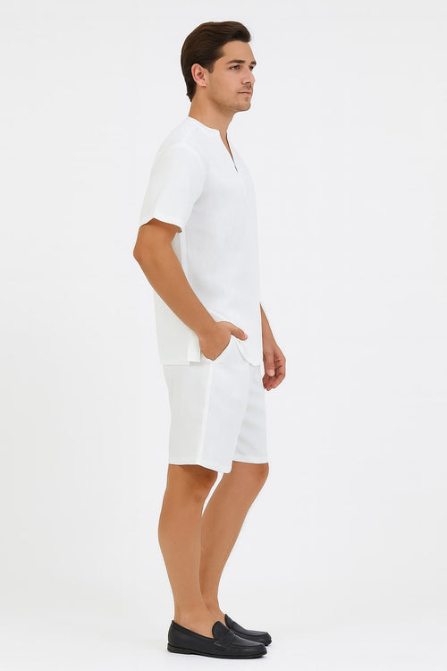 Men's white short set: V-neck short-sleeve shirt & knee-length shorts. Lightweight, plain white design. Relaxed fit shirt, side pockets on shorts. A simple, cohesive summer outfit.
