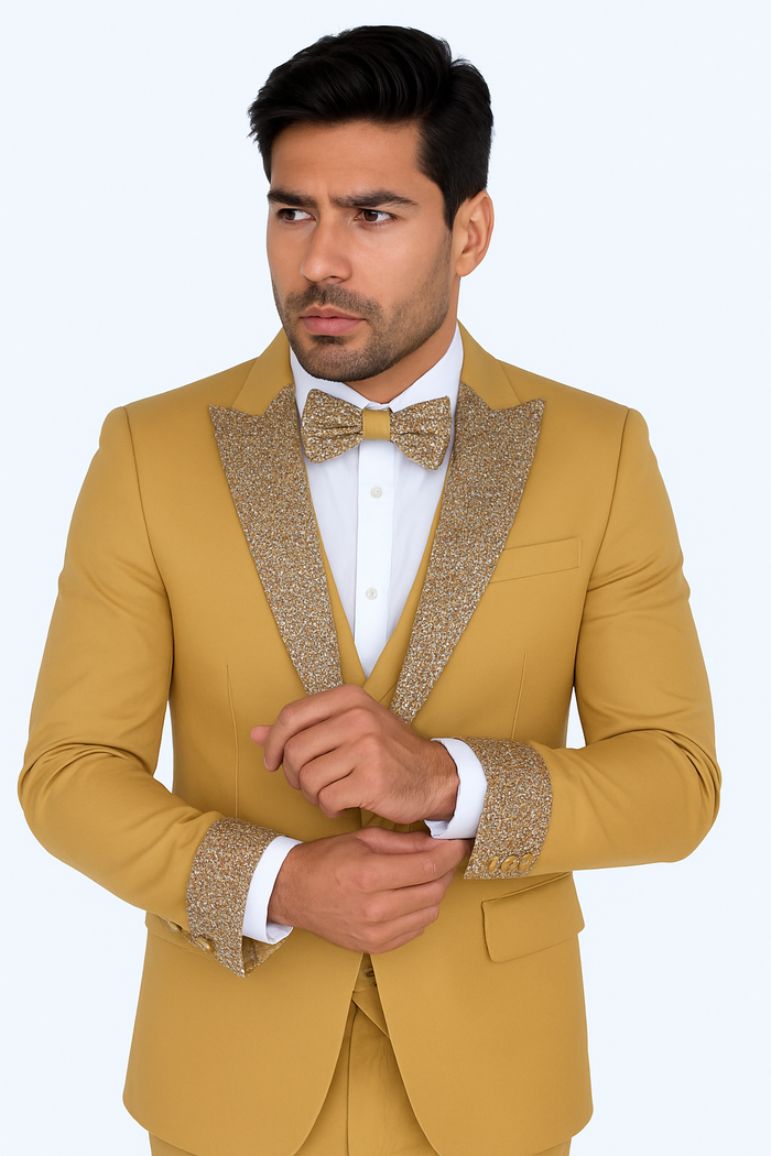 Champagne gold men's prom tuxedo with fitted jacket, textured gold lapels/cuffs. Includes white shirt, bow tie, and tailored trousers. Four-piece wedding suit.

