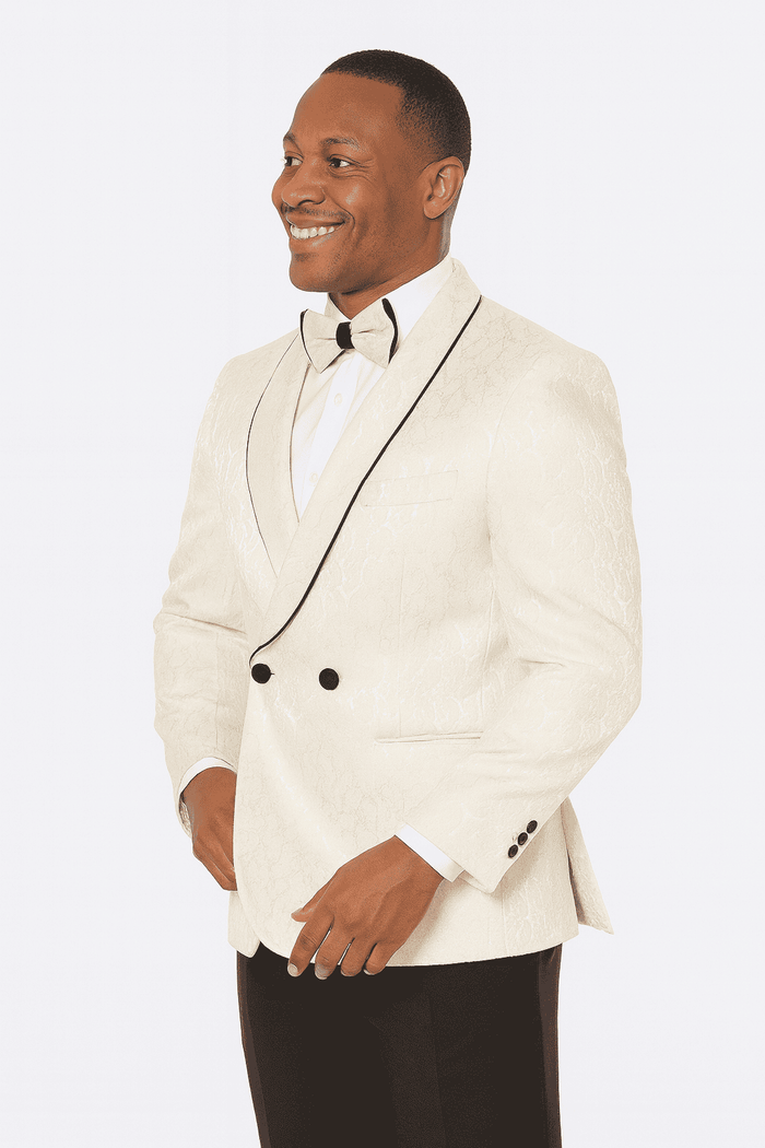 Champagne wedding tuxedo: Alberto Nardoni three-piece paisley suit. Double-breasted jacket with black lapels & ornate champagne paisley. Black trousers. Matching bow tie. Elegant & refined.
