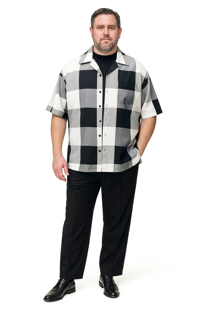 Men's black and white checkered short-sleeve shirt set. Boxy fit, button-front, large collar, chest pocket. Lightweight, breathable fabric. Paired with black trousers for casual summer wear.
