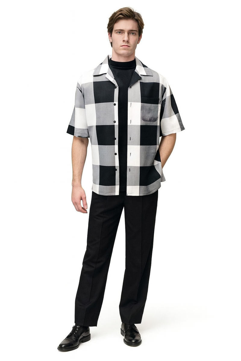 Men's outfit: Black & white checkered short sleeve shirt (button-up, collar, chest pocket) paired with solid black, straight-leg trousers.
