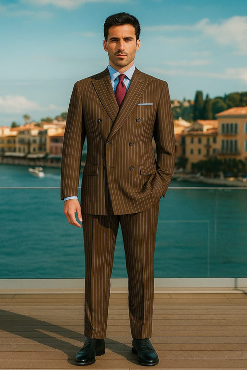 Men's brown pinstripe double-breasted suit (6-button). Structured shape, darker brown vertical stripes. Includes front and breast pockets. Contrasting light blue shirt. Matching tailored trousers.