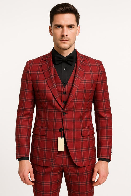 Men's burgundy plaid three-piece suit. Fitted single-breasted jacket, notch lapel, flap pockets. Matching V-neck waistcoat. Tailored trousers with straight leg. Burgundy fabric with black, green, and yellow plaid.
