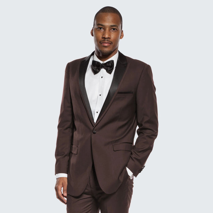Chocolate brown tuxedo with black satin peak lapel. Single-breasted, well-fitted. Includes white dress shirt & black bow tie. Smooth fabric with subtle sheen.

