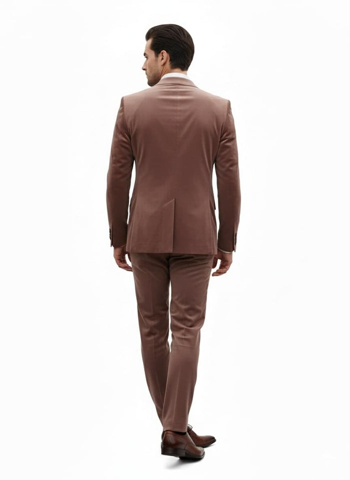 Men's light brown velvet suit. Ultra slim fit, two-piece design with blazer and pants. Smooth, soft velvet texture. Blazer features double vent, pants are fitted for a sleek silhouette.

