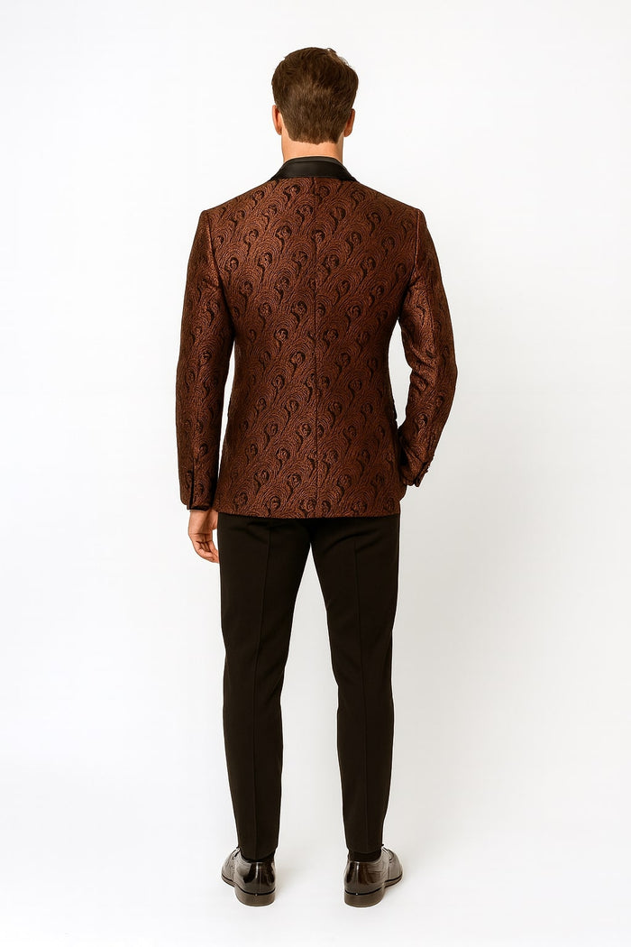 Men's rust copper paisley tuxedo jacket: fitted, patterned, black collar. Paired with black pants. Intricate paisley design.
