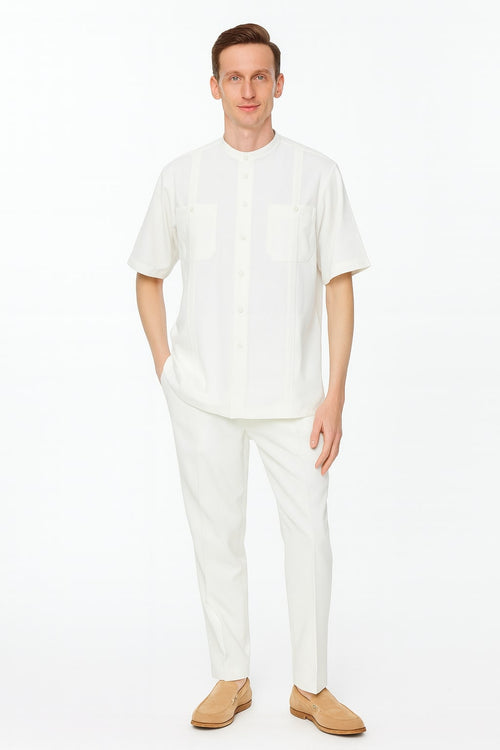 Men's linen two-piece set: white banded collar short-sleeve shirt with two front pockets and button closures, plus slim-fit pants.
