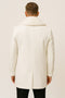 Men's white peacoat with double-breasted closure. Smooth fabric, textured collar, tailored fit to hips. Central back vent. Solid white, minimalist design.
