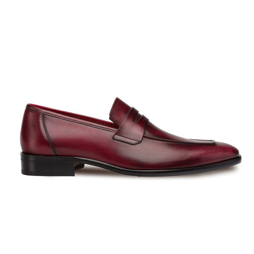 Mezlan burgundy calfskin penny loafers. Sleek slip-on design with rounded toe, penny slot, and color gradient. Black rubber sole and low heel. Classic men's style.
