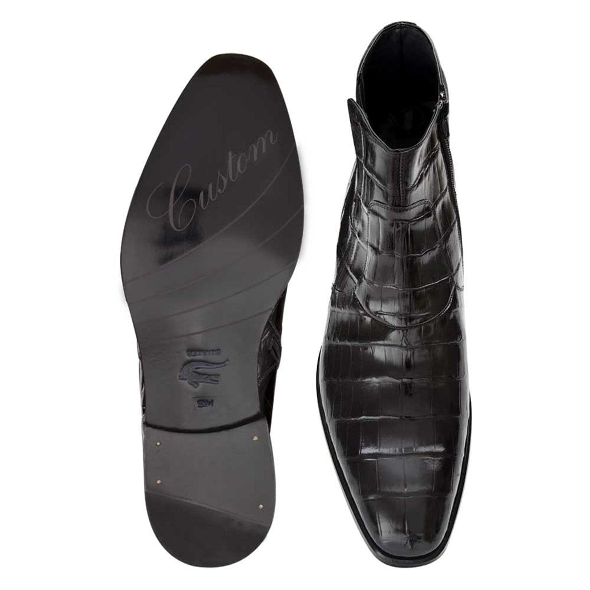 Belucci black alligator boots: ankle height, pointed toe, smooth finish. Black alligator upper with scale pattern. Black sole, embossed "Custom." Side zipper for easy wear.
