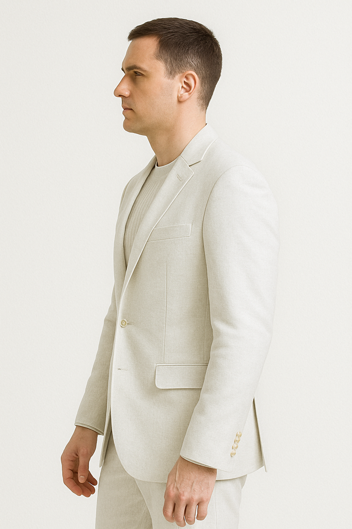 Men's light beige linen suit with relaxed fit. Features a collarless jacket (single-button, minimalistic pockets) and straight-leg trousers. Lightweight, comfortable, and designed for ease of movement.
