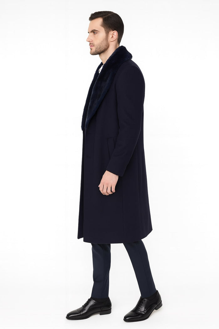 Men's navy blue long overcoat with faux fur collar. Straight silhouette, long sleeves, and possibly side pockets. Tailored for a sophisticated, versatile style, suitable for both formal and casual occasions.
