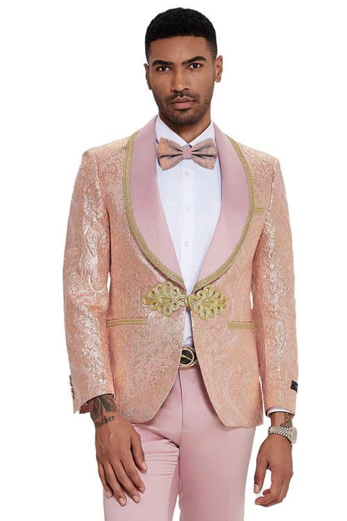 Men's shiny pink paisley tuxedo with shawl lapel. Features gold detailing, including buttons. Matching bow tie. Paired with light pants.
