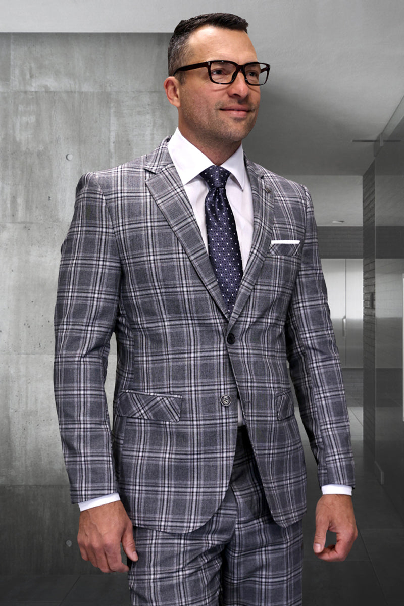 Men's modern fit Italian wool suit in taupe plaid. Features a structured jacket with notched lapel & front pockets, plus matching trousers. Gray and taupe plaid pattern.
