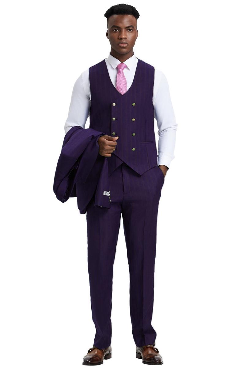 Eggplant purple Stacy Adams men's suit. One-button blazer, fitted vest (double-breasted, gold buttons), pinstripe trousers. Sharp silhouette, tailored look. Includes matching pants. Worn with a white shirt and pink tie.

