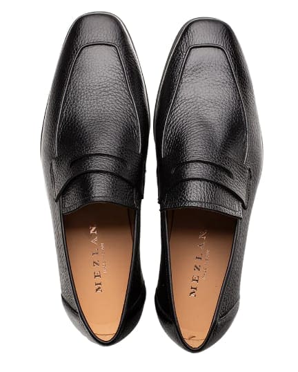 Mezlan men's black deerskin penny loafers. Smooth, textured leather upper with classic penny slot. Rounded toe, structured heel. Stylish and comfortable.
