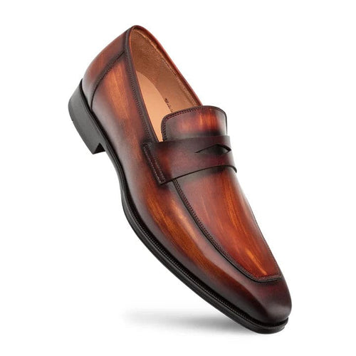 Mezlan men's penny loafers in cognac/rust. Smooth, polished leather, tapered silhouette. Slip-on design with penny strap. Structured outsole for durability and stability.
