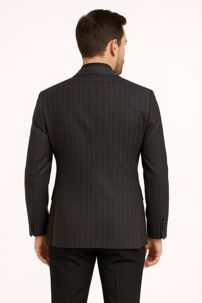 Black pinstripe blazer with a dark charcoal grey pattern. Fitted silhouette, tailored shoulders, single back vent. Long sleeves with buttoned cuffs. Smooth, formal fabric and vertical pinstripes.
