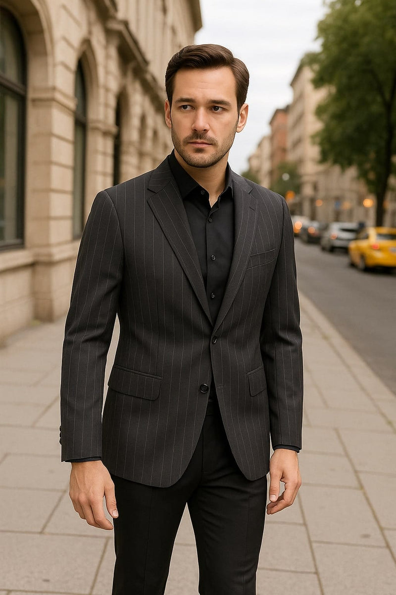 Black pinstripe blazer on charcoal grey. Tailored, single-breasted, notched lapels. Two front pockets, long sleeves. Vertical pinstripes.
