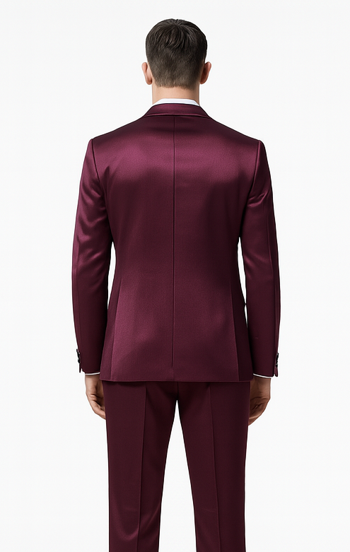 Men's purple satin three-piece suit. Slim fit, double-breasted jacket with peak lapel, straight back seam. Matching tailored trousers. Smooth, glossy finish, precise tailoring.

