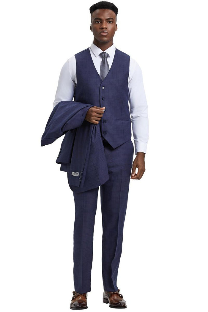 Men's Stacy Adams suit: Eggplant purple, textured fabric with windowpane plaid. Includes vest, jacket, and trousers. Features a one-button closure, wide peak lapel, and structured silhouette with a tapered, fitted hem.
