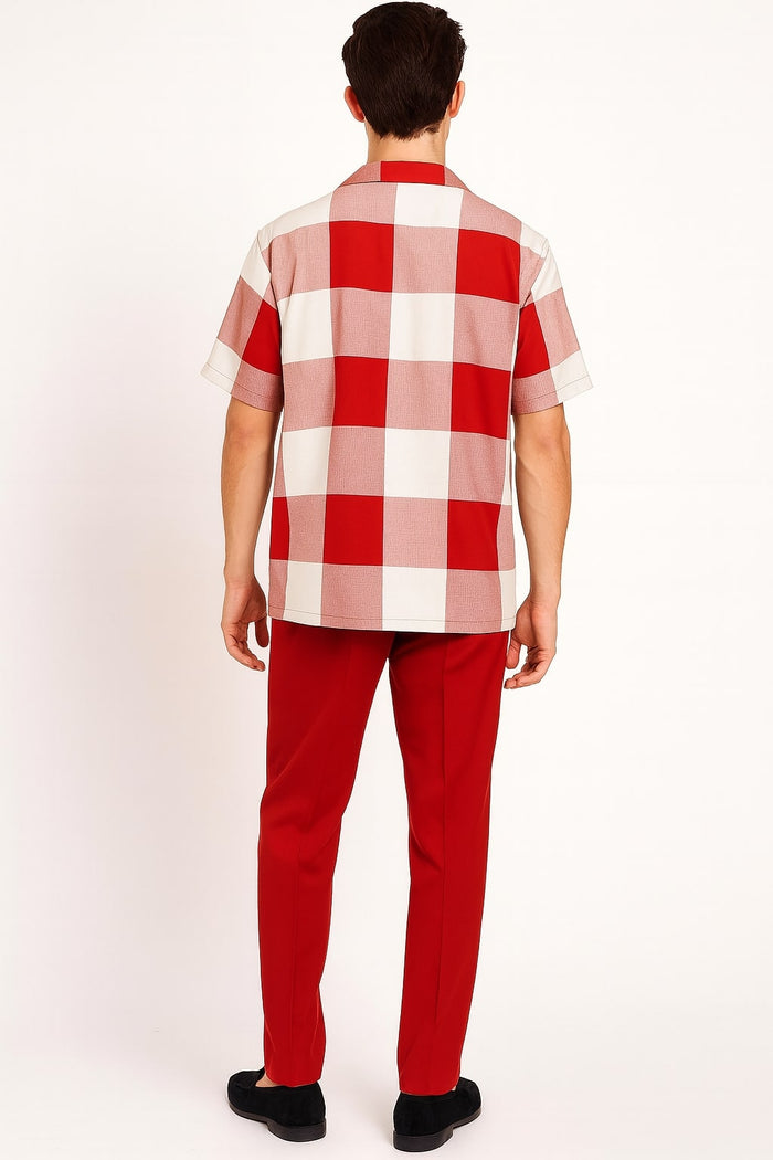 Red and white checkered short-sleeve shirt with boxy fit and spread collar. Features large squares in vibrant red and white. Paired with solid red pants for a cohesive look.
