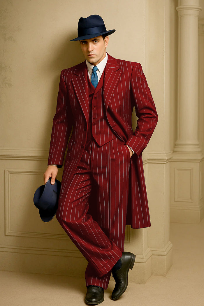 Men's red pinstripe suit: long coat, tailored jacket, trousers, waistcoat. Smooth fabric, white stripes. Classic notched lapel, long sleeves. Loose-fit trousers. Black shoes, blue tie complete the look.
