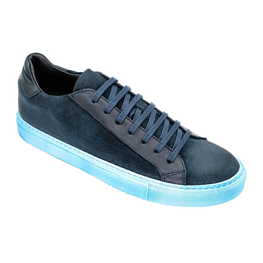 Men's Belvedere Rino sneaker. Dark blue waxed suede upper with textured blue rubber sole. Rounded toe, flat laces, and a contrasting dark heel.

