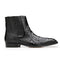 Black ostrich leather Roger boot. Pointed toe, sleek silhouette. Textured pattern, ankle height with ribbed panels. Low, flat heel, smooth sole.
