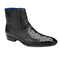 Black Belvedere Roger ostrich quill ankle boots. Pointed toe, textured quill pattern, vertical ribbed sides. Low stacked heel, blue interior lining.
