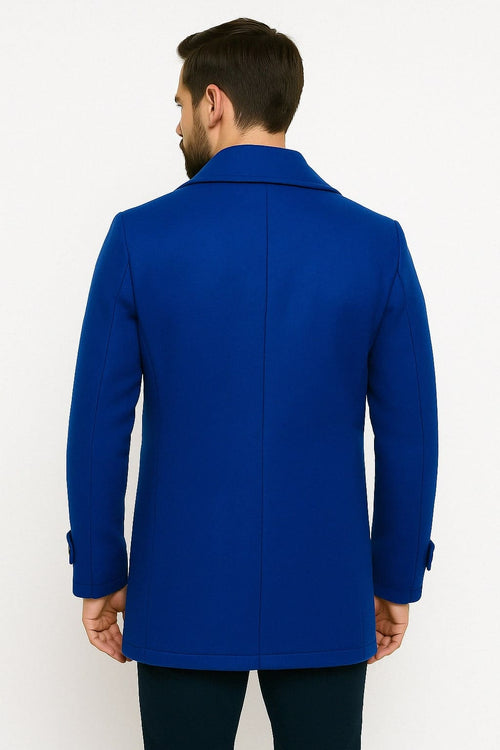 Men's royal blue double-breasted wool peacoat. Tailored silhouette, prominent collar, and buttoned cuffs. Two vertical back seams. Classic style.
