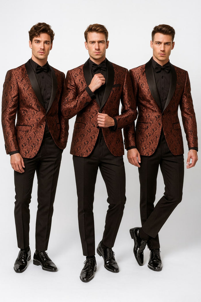Men's rust copper brick tuxedo jacket with paisley pattern, shawl lapel, and black pants. Matching bowtie. Structured design with detailed paisley fabric. Formal, cohesive look with functional pockets and smooth bowtie finish.
