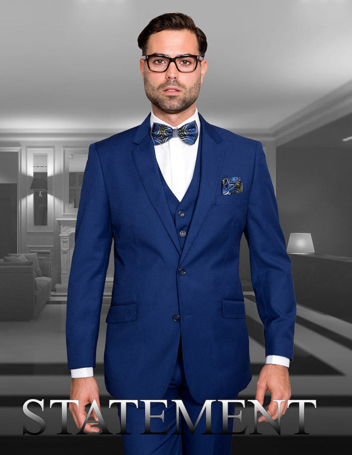 Men's Sapphire Blue wool suit with a modern fit. Includes a 2-button jacket, vest, and notch lapels. Features a solid color, two front pockets, and is crafted from wool.