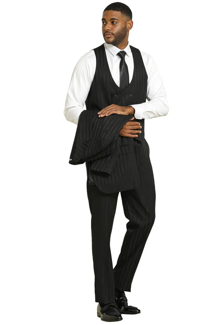 Stacy Adams modern fit black suit with tonal shadow pinstripes. Features a vested design, tailored jacket, and matching trousers. Includes double-breasted vest. Styled with white shirt and black tie. Sleek and structured.
