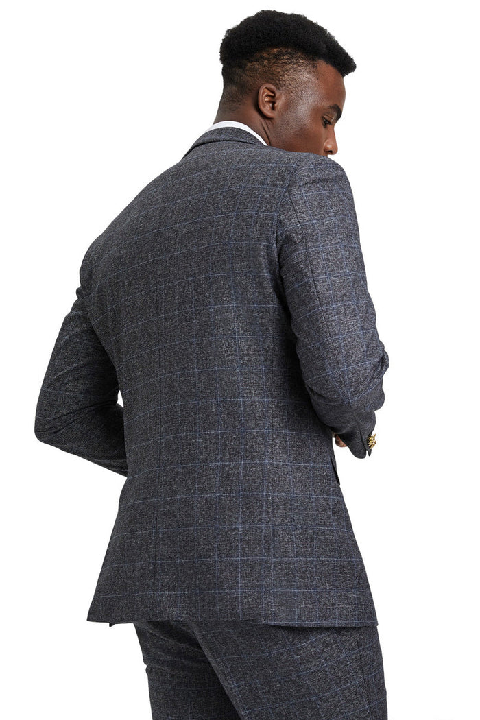 Charcoal grey plaid Stacy Adams men's suit. Tailored fit, structured silhouette with peak lapel. Features a fitted vest. Subtle plaid pattern on grey base for a formal, streamlined look.
