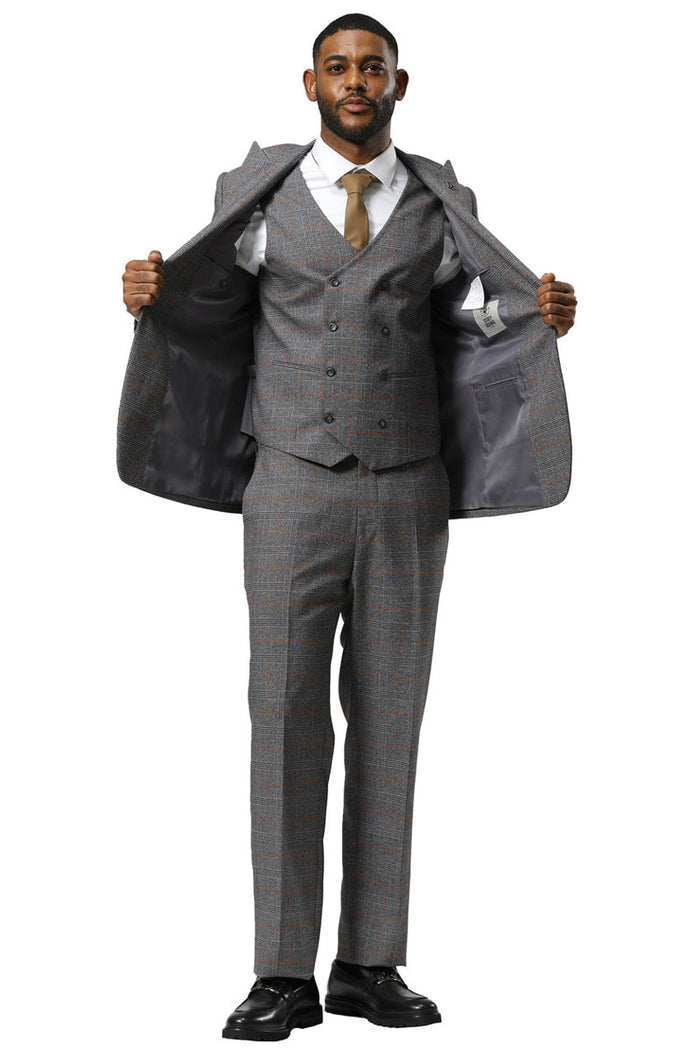Men's Stacy Adams suit: Grey glen plaid with a double-breasted vest. Fitted, tailored silhouette. Features a one-button peak lapel jacket, various grey shades, and brown accents in the plaid. Includes matching tailored trousers.
